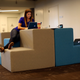 Inside Twitter, a woman wears a common uniform in Silicon Valley: jeans, a basic top, and flats.
